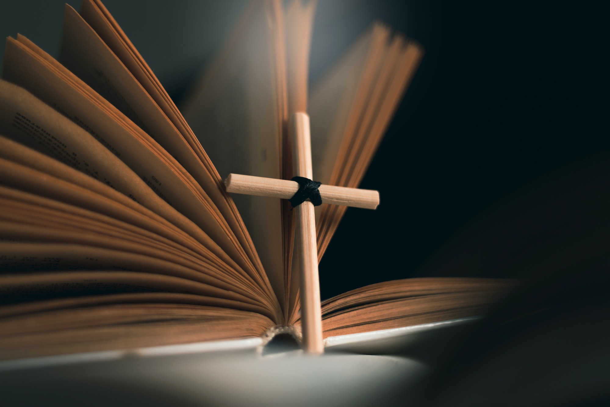 Homemade cross on an open Holy Bible book. Cross in open Bible.
